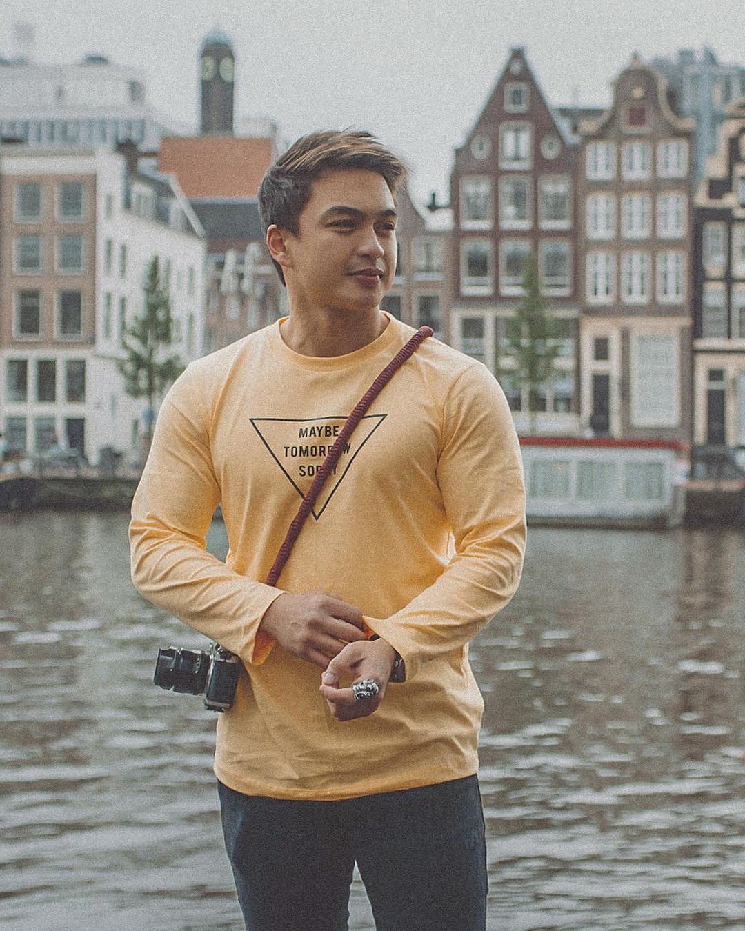 Dominic Roque with a camera in yellow t shirt 