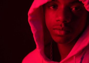 Music Artist Tootie Raww in red hoodie