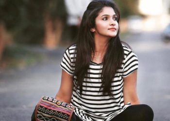 Actress Divya Uruduga sitting on a road