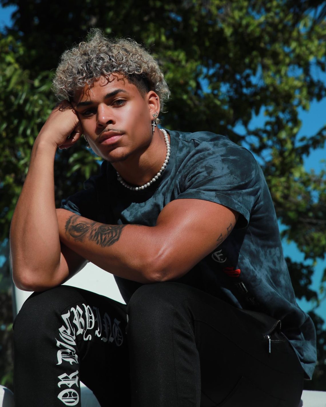 Tony sitting with right hand on his forehead