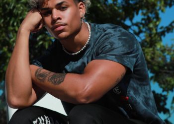 Tony sitting with right hand on his forehead