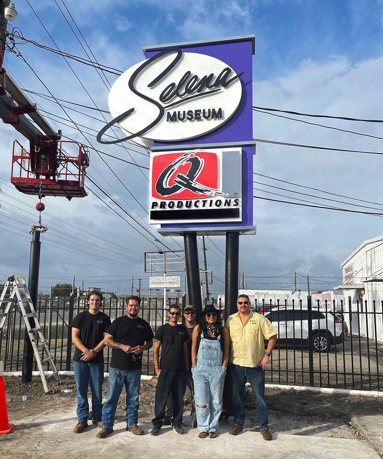 Suzette Family in front of the board of selena's museum