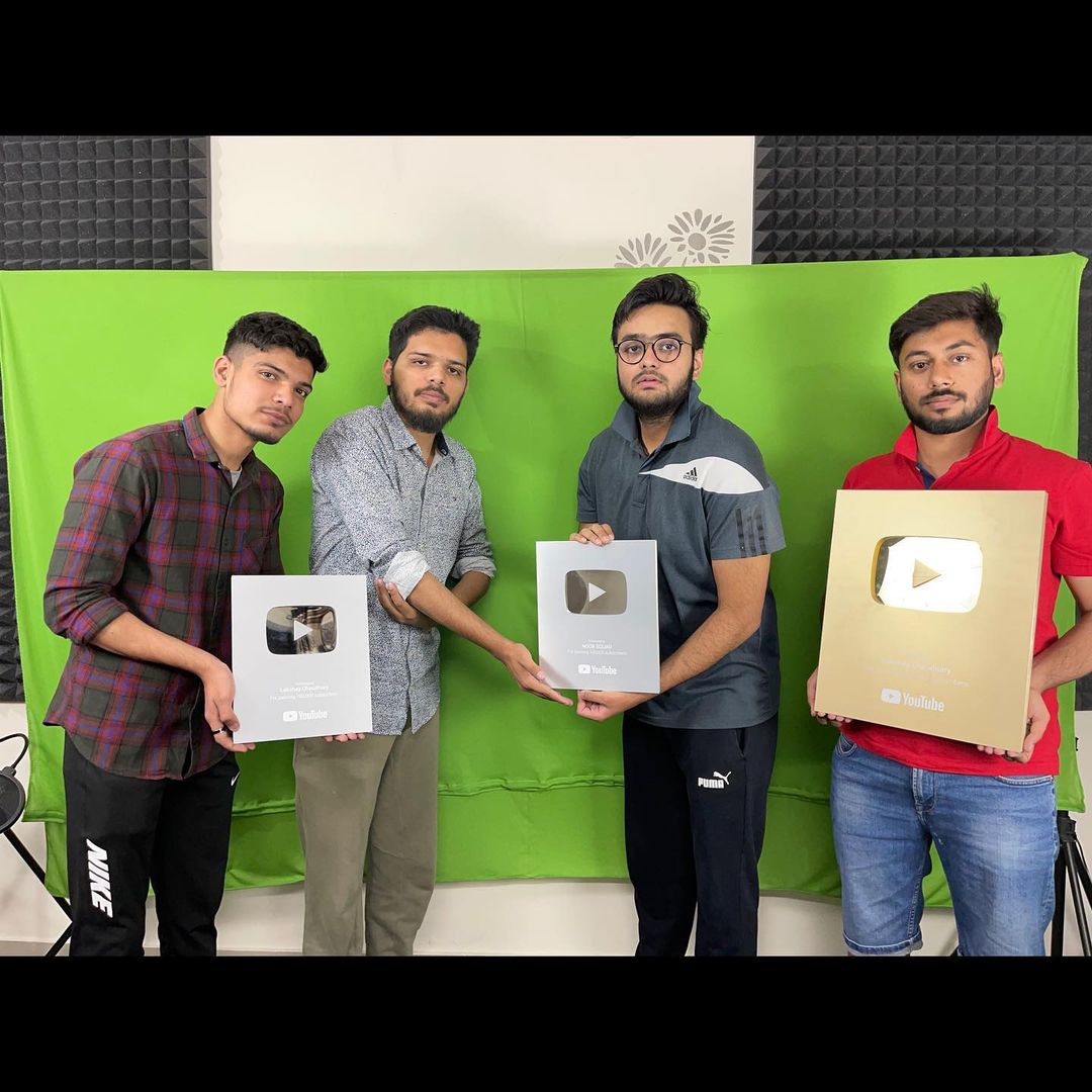 Lakshay and his team with silver and golden YouTube play buttons. 