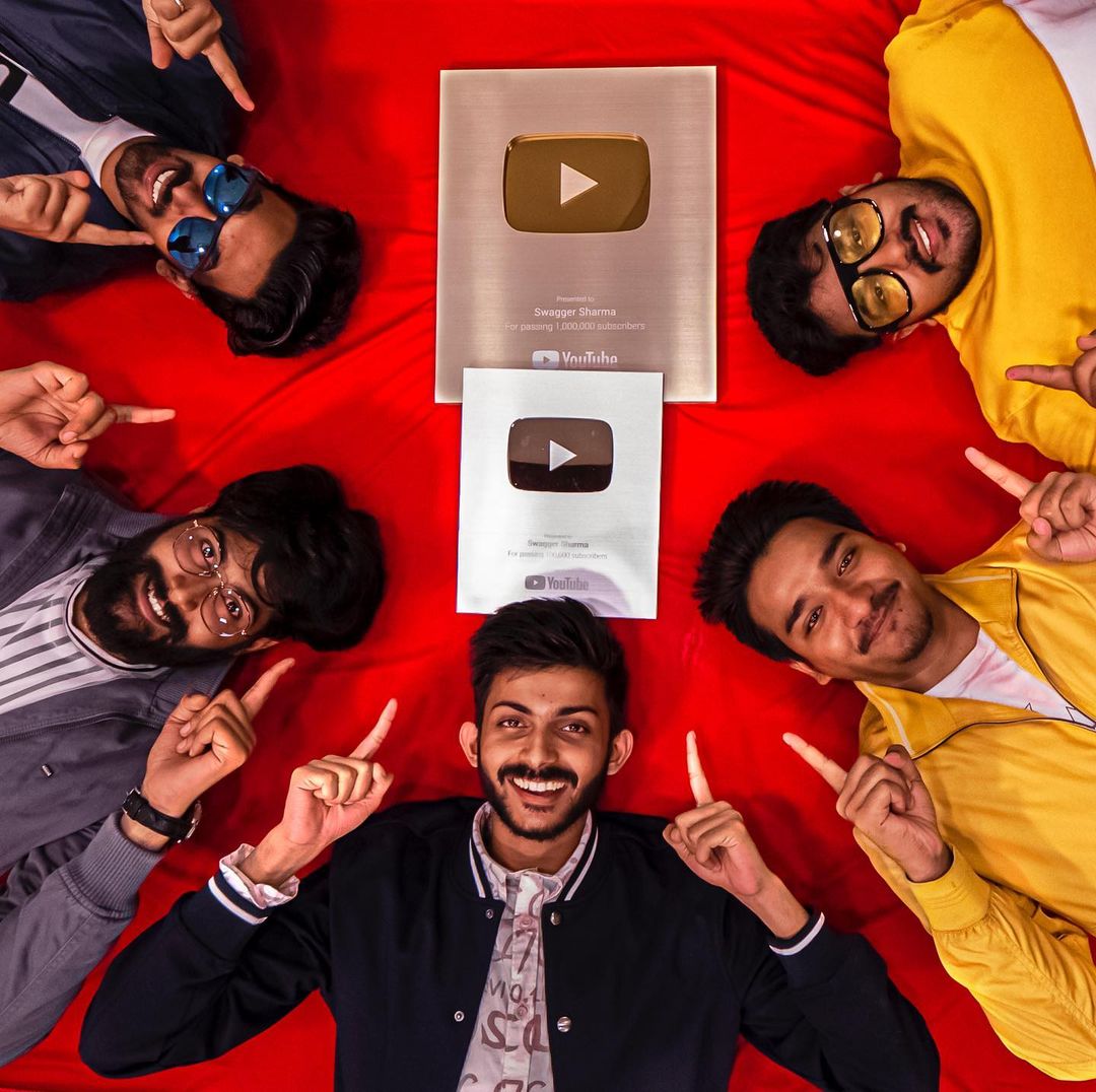 Shivam and his team with Youtube silver and golden play buttons. 