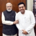 Sambit Patra standing next to the PM of India.