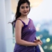 Amritha Aiyer standing in purple saree