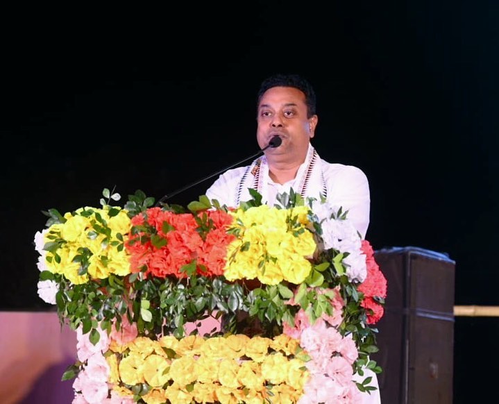 Sambit Patra speaking on the podium. at an event. 