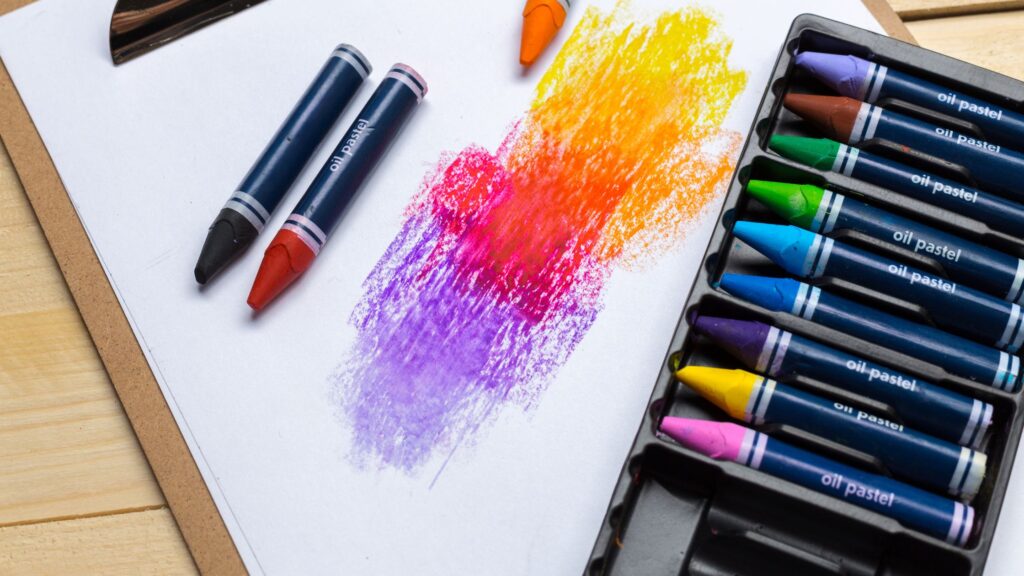 a picture of multiple crayons with a paper.