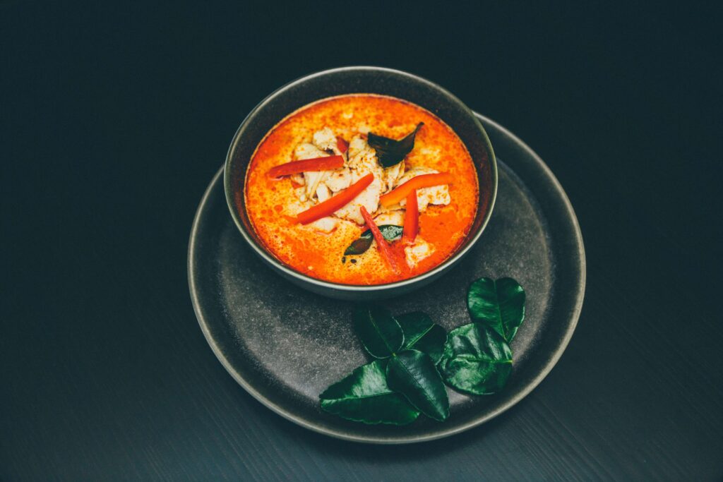 Thai red curry in black bowl