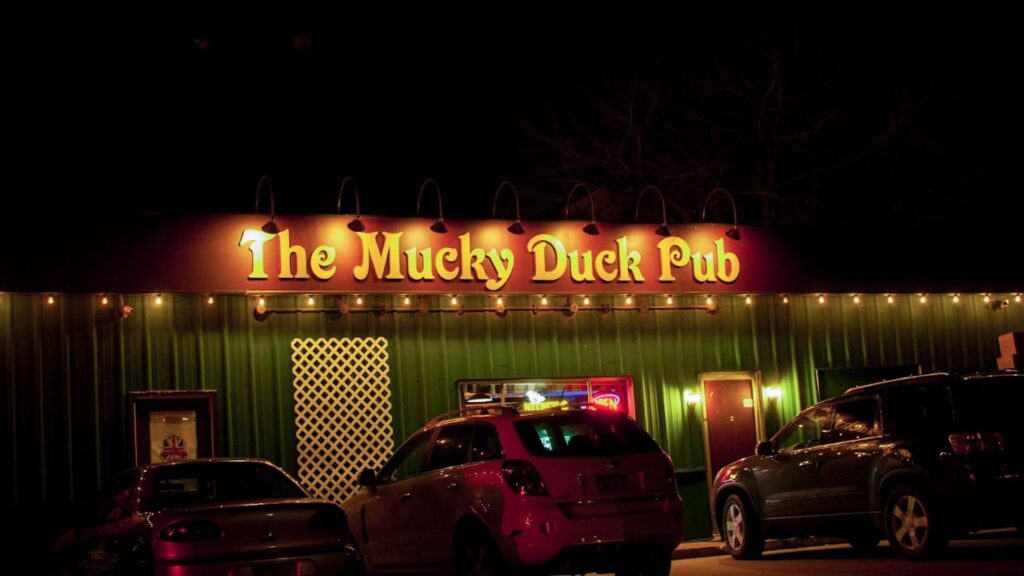 Cars parked outside The Mucky Duck Pub.