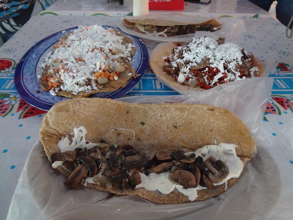 Three plates of Huaraches served on the dining table.