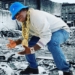 Tracy Morgan wearing a blue hat and jeans and white shirt with gold chain.