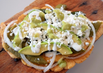 Huaraches Mexican Food served on the wooden utensils.