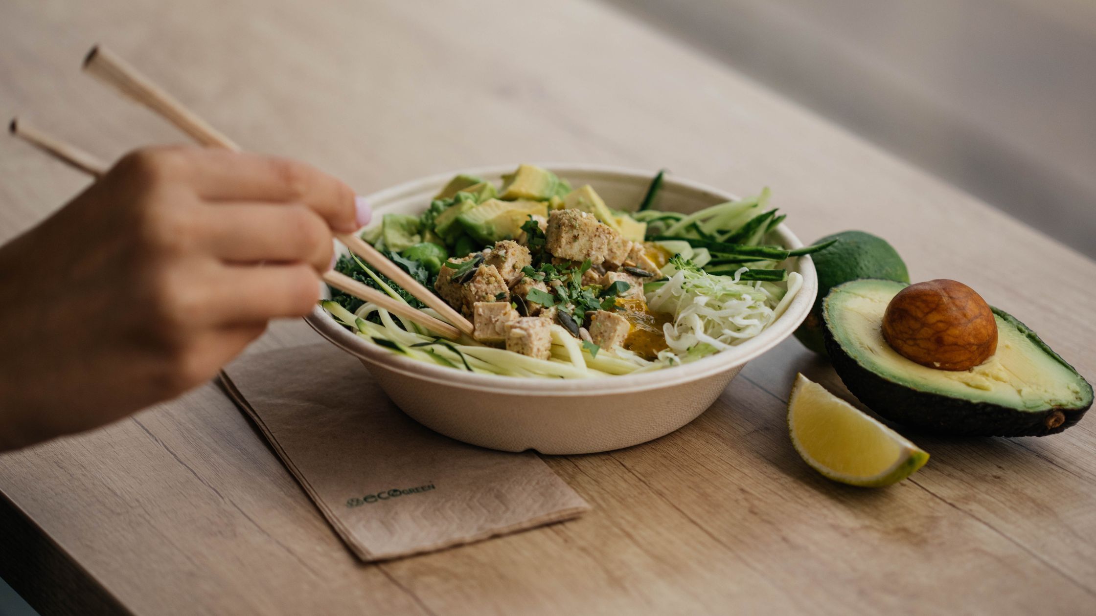 A person eating Tofu mixed in a vegetable meal.