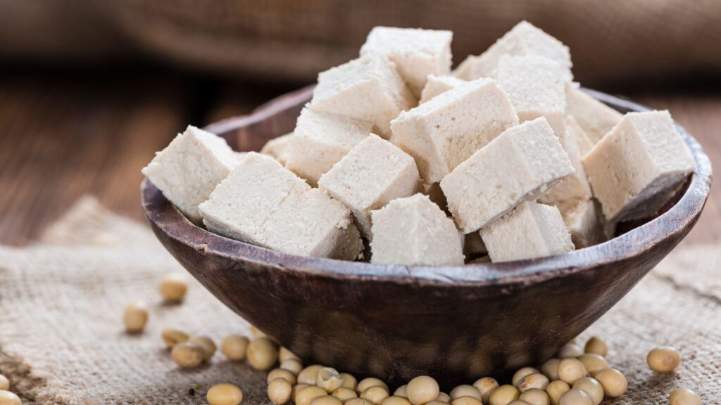 Raw Tofu cubes in a black colored bowl.