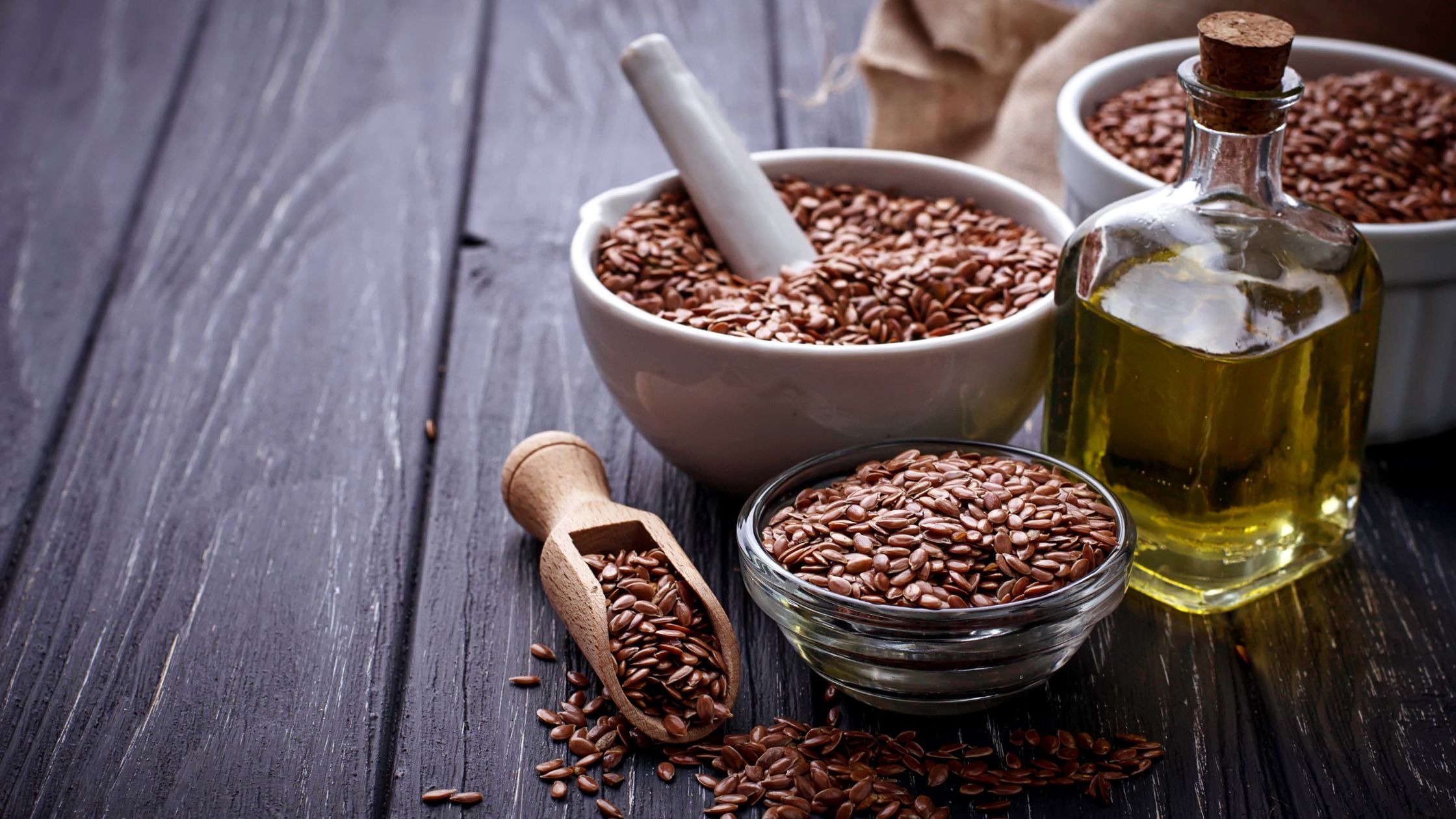 Three bowls of Aliv seeds placed on a brown colored table.