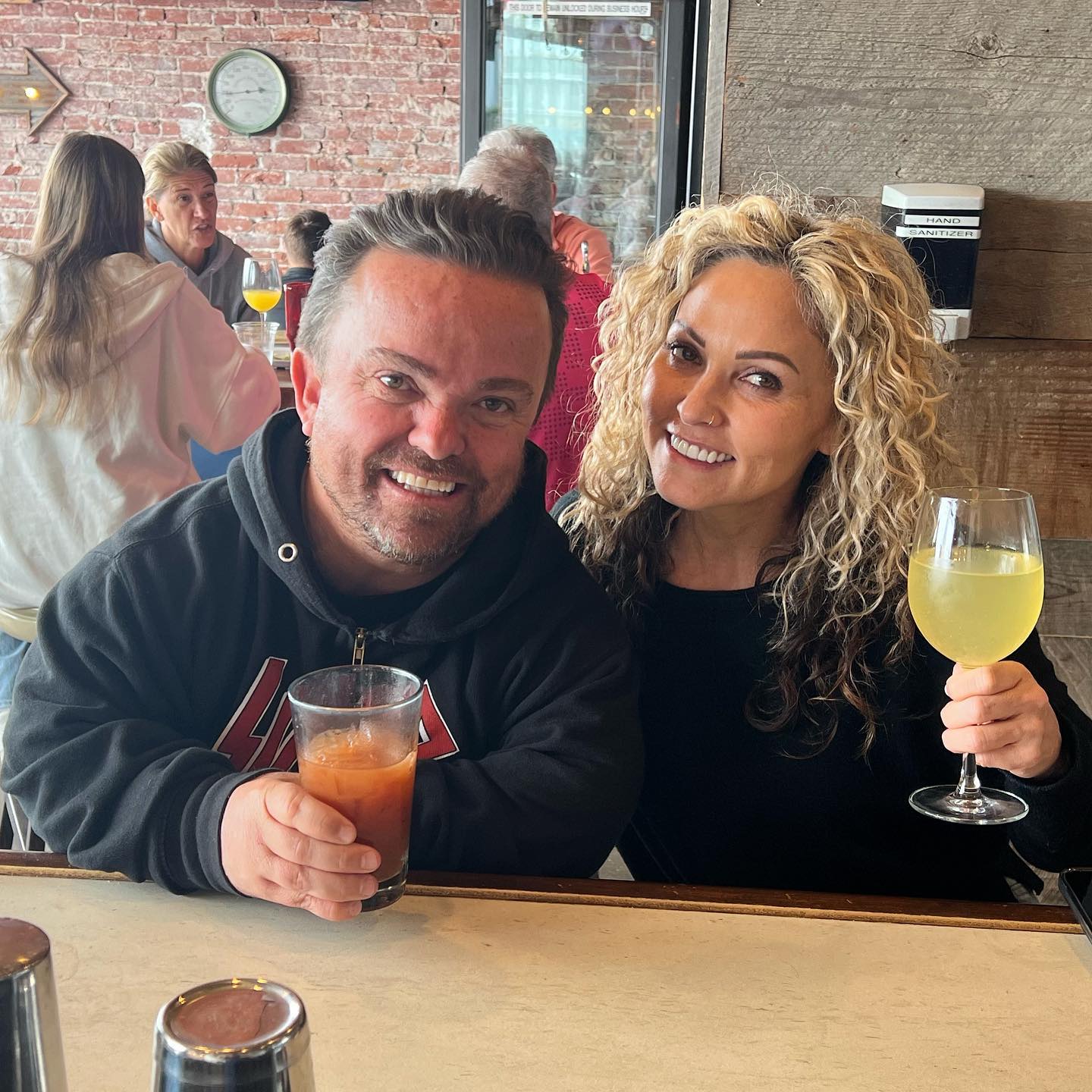 Wee Man enjoying drinks with his partner.