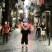 Wee Man standing on the streets of Italy.