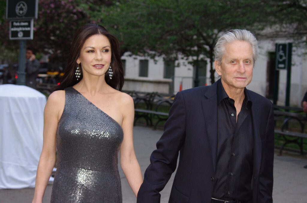 Catherine Zeta Jones Michael Douglas holding hands.