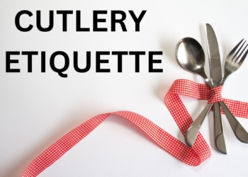 Fork spoon and knife tied with a ribbon.