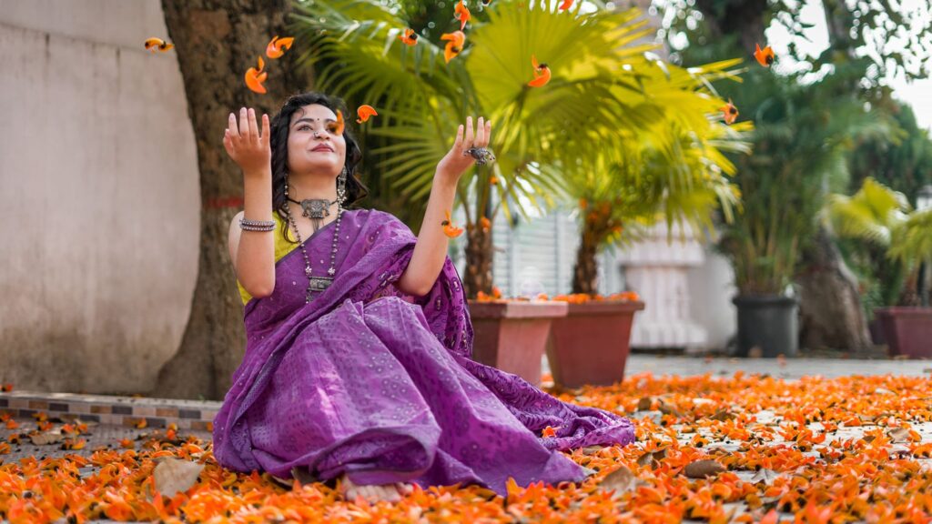 A girl wearing purple colored saree