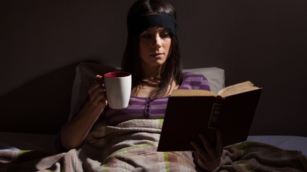 A girl reading book before bed time