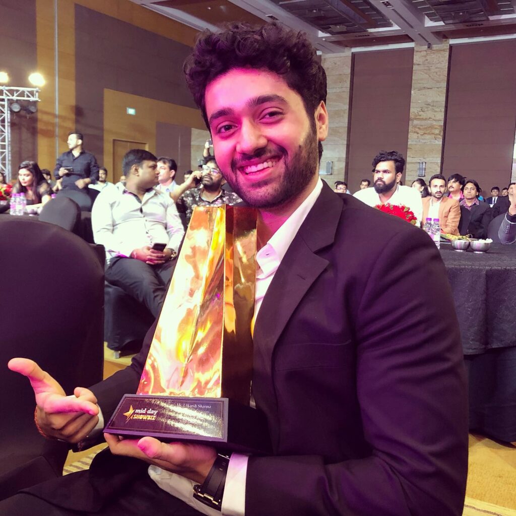 Utkarsh holding his Best Male Debut award for "Genius"