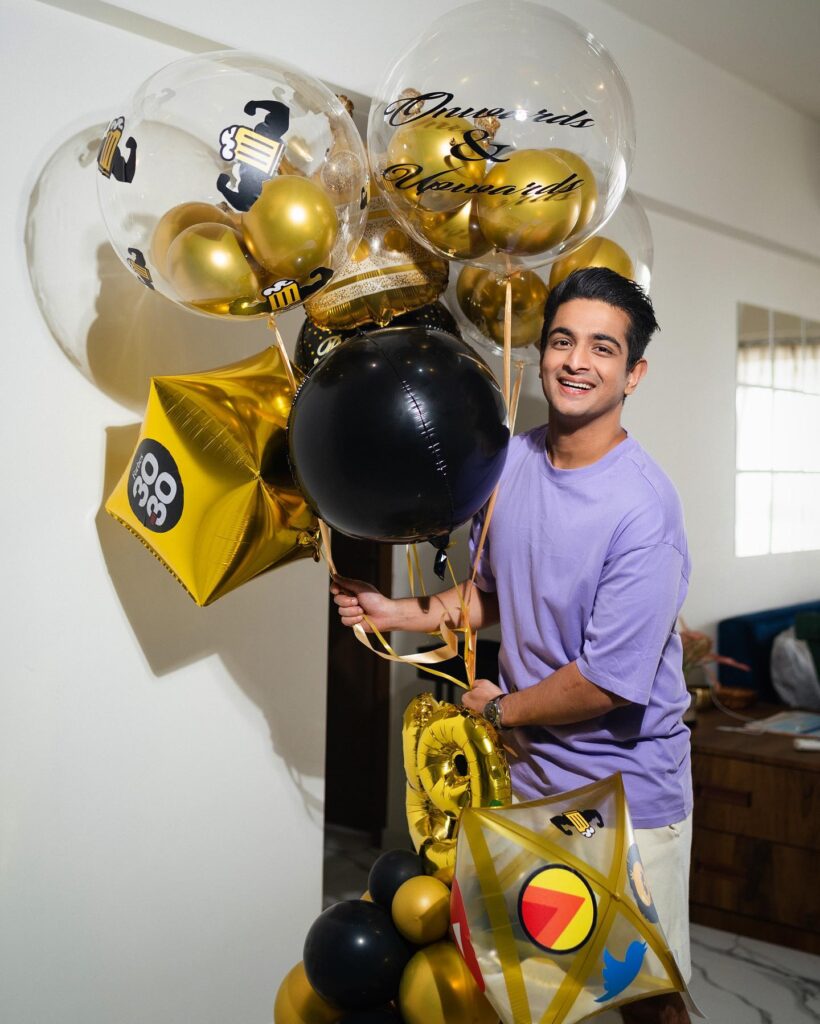 Ranveer Allahbadia holding balloons celebrating birthday